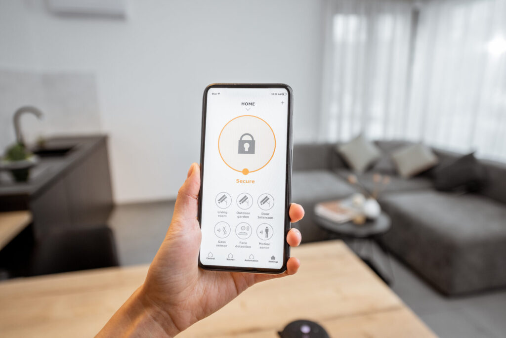 Smart home security app on a smartphone showing an armed system in a modern living room