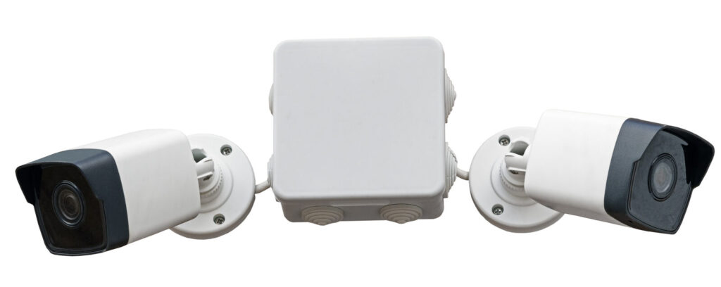 Two white smart home security cameras positioned either side of a white hub