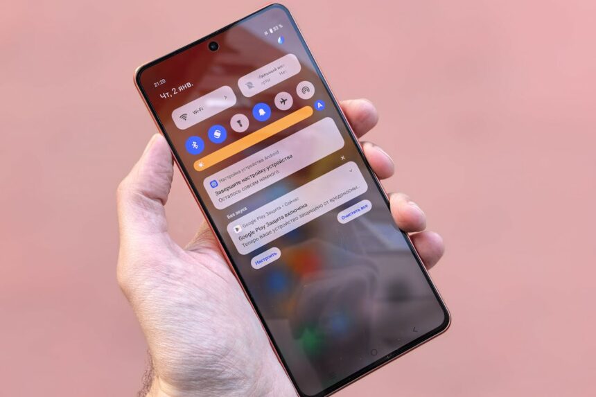 A person holding a phone with best android apps to try